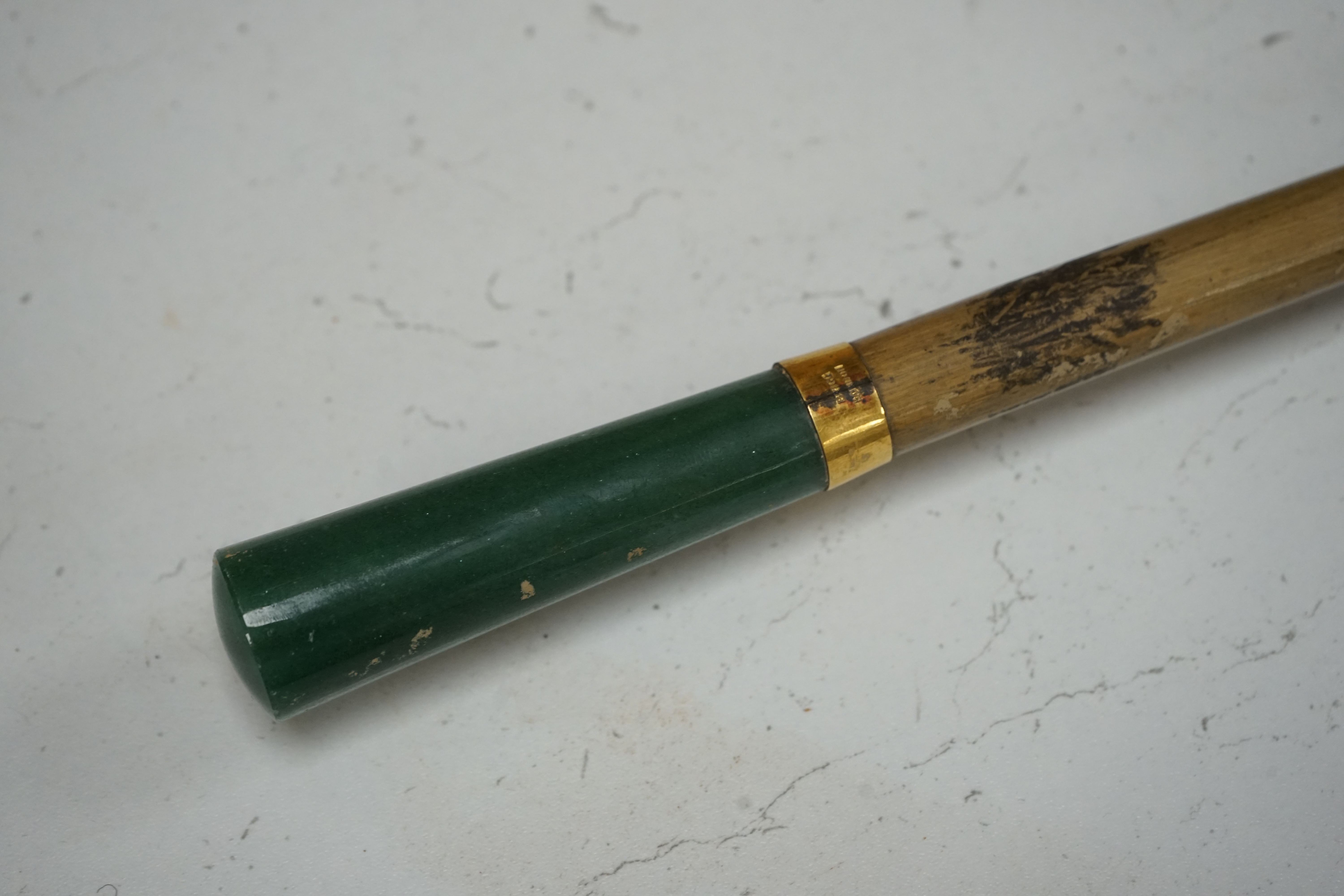 An umbrella, with aventurine quartz handle and yellow metal collar inscribed Brigg, London. (With cover) umbrella 101 cm long. Condition - silk poor, handle good